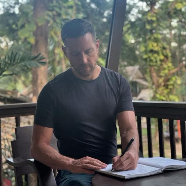Pete Scott writing in a notebook